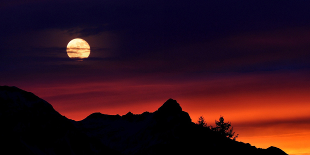 A Beautiful View of a moon and mountain